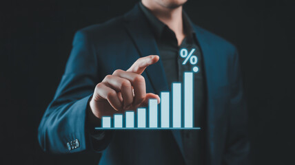 A professional business photo of a hand in a dark navy suit jacket interacting with a holographic financial chart on a dark background.