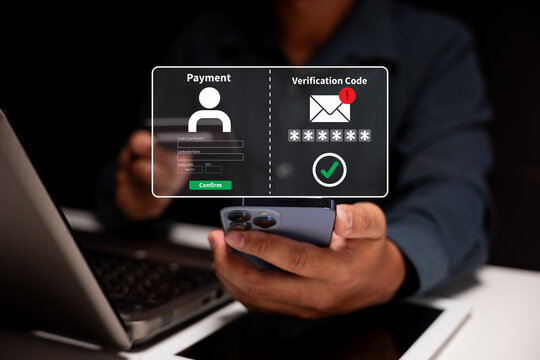 A person uses a smartphone and laptop to complete an online payment with a verification code for secure authentication.