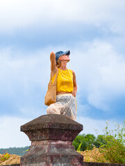 A woman posing at ancient ruins in Nha Trang, Vietnam - a moment of silence amidst the historical heritage and nature of Southeast Asia. Tourism concept