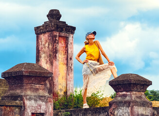A woman posing at ancient ruins in Nha Trang, Vietnam - a moment of silence amidst the historical heritage and nature of Southeast Asia. Tourism concept