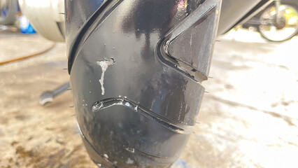 Checking motorcycle tires for holes with soapy water