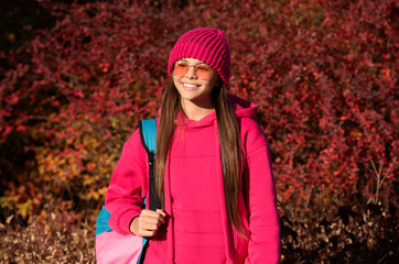 teen girl in autumn park outdoor. autumn is a time to study. knowledge and education. school education. back to school. autumn girl carrying school bag. education for adolescence. high school