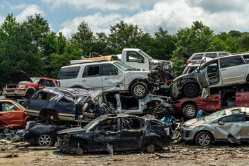 A pile of wrecked cars in a scrap yard