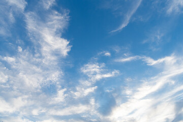 Blue sky with clouds in the sky. Sky clouds background. White cloudy Heaven with soft sun light. Clouds on pastel blue sky background.