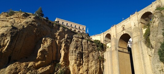 Beautiful old stone bridge at sunset. Useful street in the old town. Scenic view from the path in the mountains. European landmark for sightseeing. Must-see grand canyon national park.