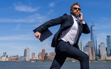 Businessman running to success. Business success. Successful businessman hurrying on New York city skyline. Business man in Manhattan. Business success in big city. Advertisement