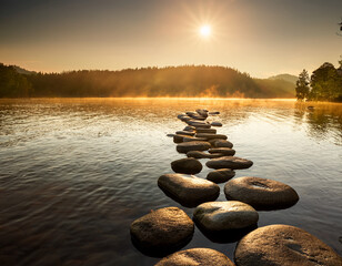 Serene Lake Sunset with Rocky Shoreline and Distant Mountains