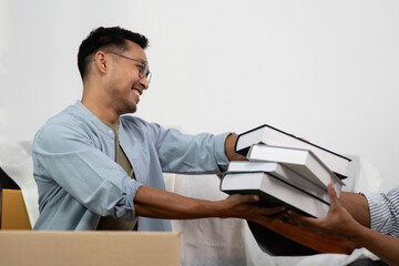 Gay couple sharing joyful moments while unpacking boxes together