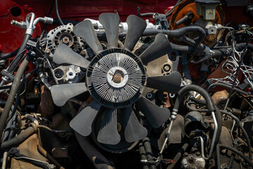 A wrecked truck with some of its engine parts removed
