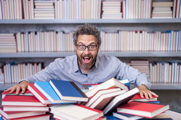 genius studying homework literature near pile of books. man teacher read book. school education in college. knowledge day. overwork of bookworm. teacher genius in school library. study with book