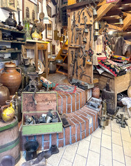 An antique shop with vintage household items, textiles, dishes and a cozy atmosphere.