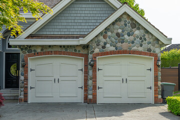 Garage door in luxury house with trees and nice landscape in Spring in Vancouver, Canada, North...