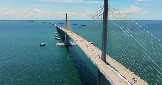 Sunshine Skyway Bridge over Tampa Bay in St Petersburg in Florida with driving traffic cars. Transportation infrastructure in USA