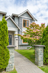 Entrance of painted luxury house in spring with stair steps and nice landscape in Vancouver, Canada, North America. Day time on May 2025.
