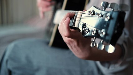 Woman Practicing Guitar in Cozy Room at Home. Strumming black acoustic guitar. Female learning to play music. Person hand on a guitar neck. Guitarist working on melody, performance, practice indoors - Powered by Adobe
