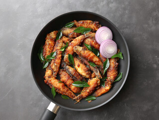 Savory Fried Fish Dish: This image showcases a tantalizing dish of fried fish, artfully arranged in a sleek pan, garnished with aromatic herbs and sliced onions.