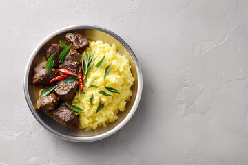 Exquisite Culinary Composition: A vibrant close-up showcases an enticing food arrangement, featuring expertly cooked meat and a fluffy, yellow accompaniment.