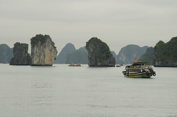 February 25, 2024, Lan Ha Bay: Tourist boat and limestone cliffs. Cat Ba Archipelago. Vietnam.