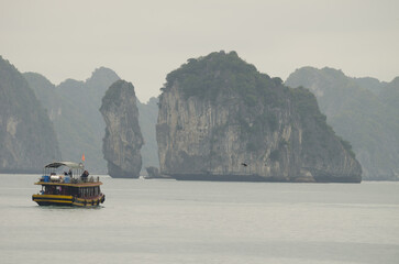 February 25, 2024, Lan Ha Bay: Tourist boat and limestone cliffs. Cat Ba Archipelago. Vietnam.