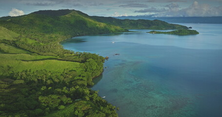 Aerial drone footage revealing the stunning beauty of a tropical Fiji island, showcasing lush...