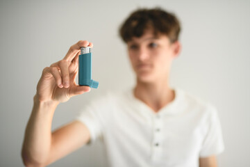 teen having an asthma problem in studio gray