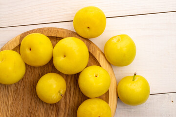 Bright yellow plums, top view, macro.