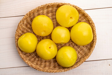 Bright yellow plums, top view, macro.