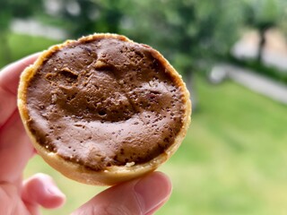 Hand-held chocolate egg tart with a creamy caramelized top