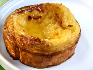 A golden custard Danish pastry with a caramelized top and a flaky, buttery crust