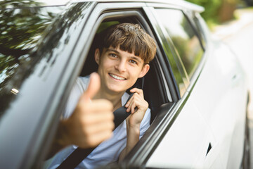 teen girl driver on car on summer day