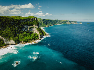 Fototapeta premium Aerial View of the Rugged Coastline of Nusa Penida, Indonesia – Blue Ocean and Cliffs