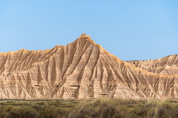 Bardenas reales natural park showcasing eroded sandstone formations under blue sky