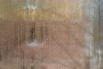view from the apartment through the wet window you can see the house opposite