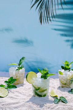 Refreshing mojitos with mint and lime on sunny beach