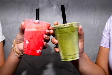 Friends enjoying colorful smoothies at a healthy bar