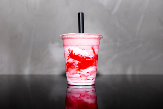 Refreshing strawberry and cream shake in plastic cup