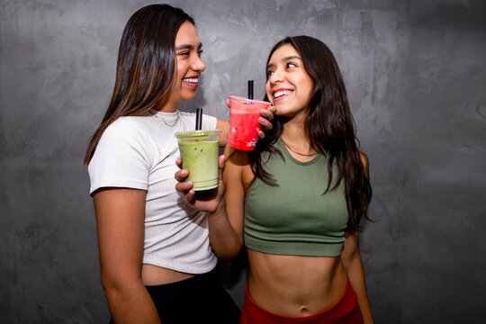 Two women enjoying healthy and refreshing fruit smoothies - Powered by Adobe