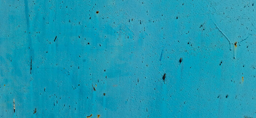 Metal painted with blue paint. Scratched paint, rusting metal.