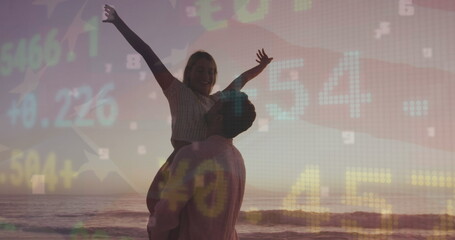 Lifting romantic couple embracing at sandy shoreline with waves during sunset, with market overlay