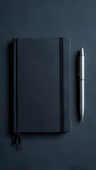 Black notebook and silver pen on dark background for writing journaling and note taking concept design