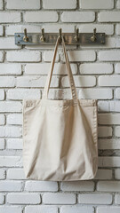 Tote bag mockup hanging on hooks against a white brick wall for product display and marketing use case