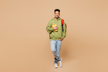 Full body young smart happy fun boy student he wears green casual clothes backpack bag hold books...