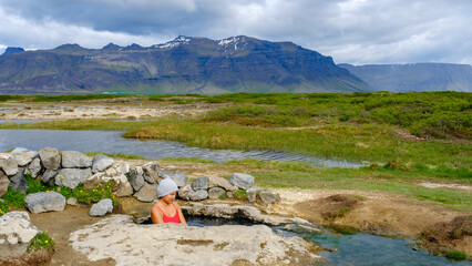 Relaxing in Landbrotalaug Hot Spring surrounded by Icelands stunning landscapes