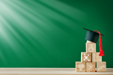 Stacked pyramid of wooden blocks with icon scientific symbols on green blackboard or chalkboard background. Concept education, development and learning. Empty background. Back to school concept.