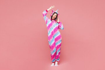 Full body young happy woman she wear domestic costume with hoody and animal ears show victory sign...