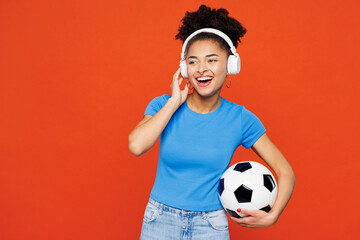 Young woman fan in basic blue t-shirt cheer up support football sport team hold in hand soccer ball...
