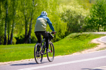 Cyclist ride on the bike path in the city Park
