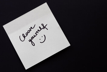 Handwritten sticky note with 'Choose yourself' inscription on black background