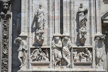 Milan, Italy - Candoglia marble statues and bas reliefs on the facade of the Duomo cathedral