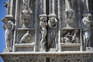 Milan, Italy - Candoglia marble statues and bas reliefs on the facade of the Duomo cathedral